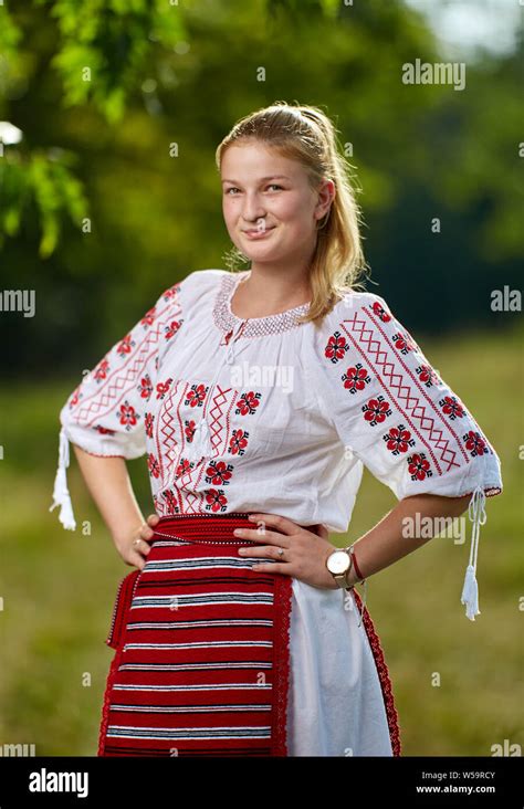 Portrait Of A Romanian Girl In Traditional Costume In An Oak Forest