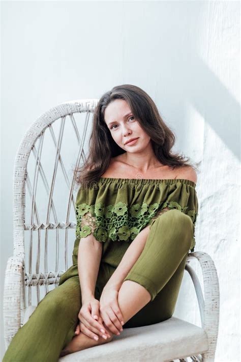 Beautiful Fashionable Slim Brunette Woman Sitting On A Chair And Smiling Stock Image Image Of