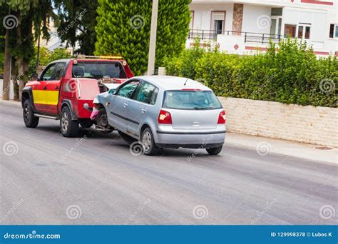 Crashed Car Being Towed Away by Tow Truck after Accident Stock Photo ...