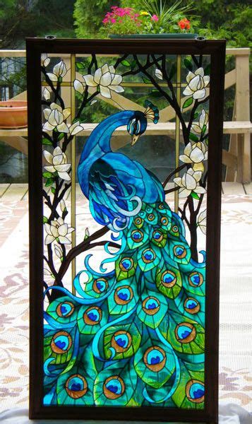 A Stained Glass Peacock Sitting On Top Of A Wooden Frame With Flowers