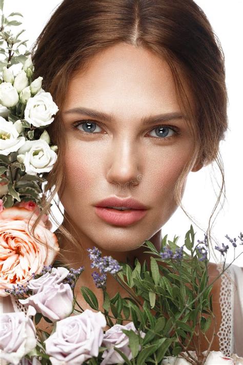 Beautiful Woman With Classic Nude Make Up Light Hairstyle And Flowers Beauty Face Stock Photo