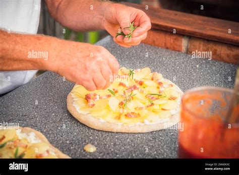 Baker Man Making A Tasty Pizza With Potato And Bacon Spiced Up With