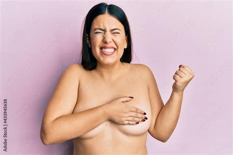 Beautiful Brunette Woman Standing Naked Covering Breasts Screaming Proud Celebrating Victory