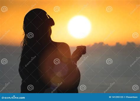 Naked Beautiful Female With Wet Hair Wrapped In A Blanket With Cup Of Coffee Standing On The