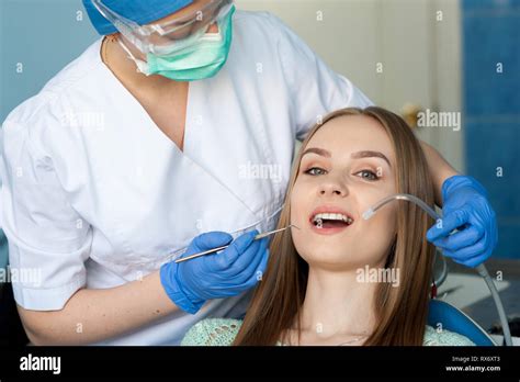 Dentist Examining A Patients Teeth In The Dental Clinic Stock Photo