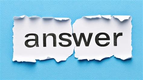 Premium Photo | Two torn paper pieces displaying the word answer in