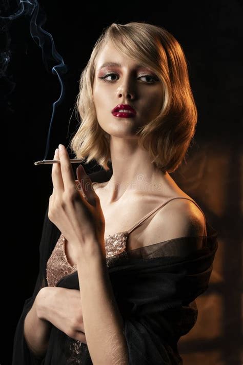 Cute Face Blonde Girl With Vintage Style Hairstyle Wearing A Golden Sparkling Dress And Black