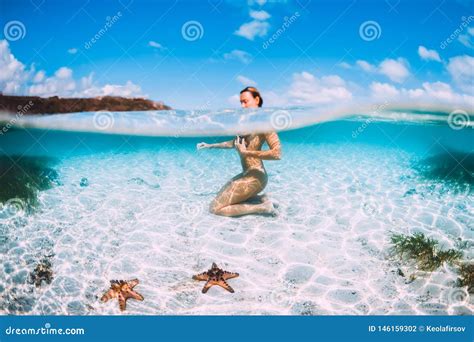 Naked Woman Swim In Blue Ocean With Starfish Underwater In Tropical Sea Stock Photo Image Of
