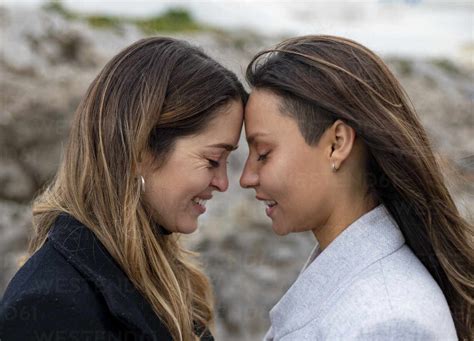 Smiling Lesbian Couple Touching Forehead Stock Photo