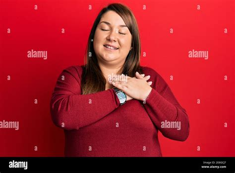Beautiful Brunette Plus Size Woman Wearing Casual Clothes Smiling With Hands On Chest With