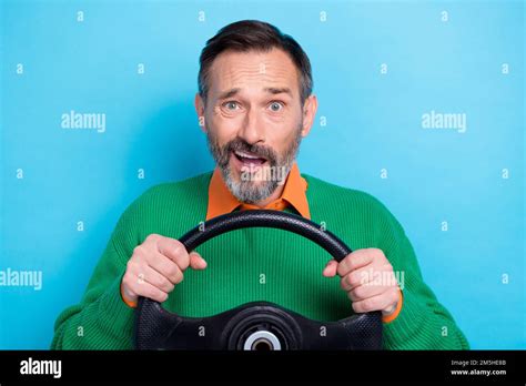 Portrait Of Mature Aged Grey Hair Man Wear Green Jumper Shirt Driving New Car Steering Wheel