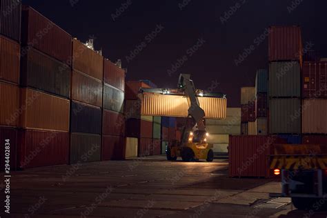 reach stacker puts container  stack industrial port  containers