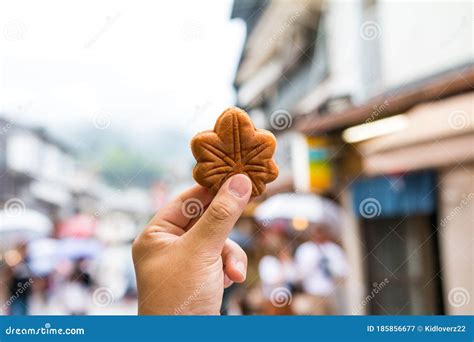 Hand Holding A Japanese Hiroshima Traditional Maple Leaf Shaped Cake