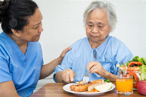 Asian senior or elderly old lady woman patient eating breakfast ...