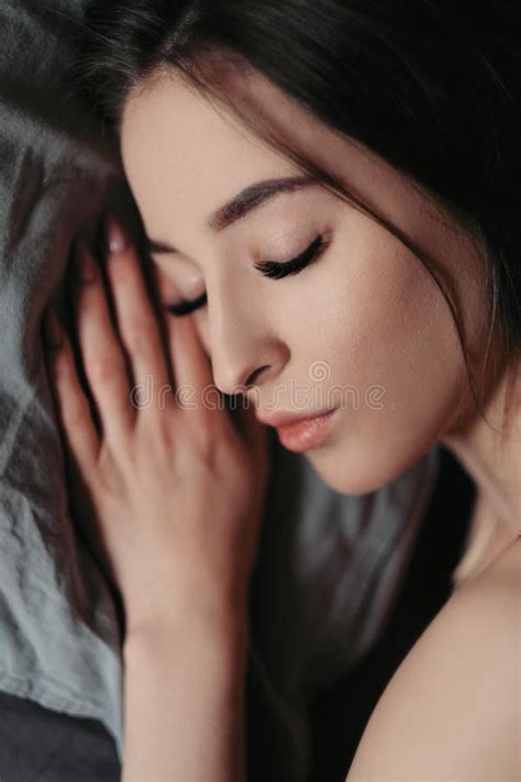 Beautiful Brunette Woman Is Lying On The Bed Face Close Up Beautiful Brown Eyes Lips And