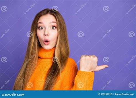 Portrait Of Youth Blonde Hair Shocked Girl In Orange Turtleneck Pointing Finger Empty Space