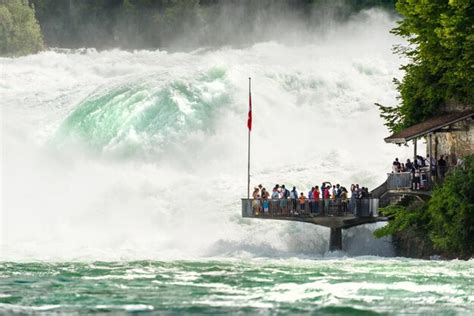 Premium Photo People Standing Against Waterfall