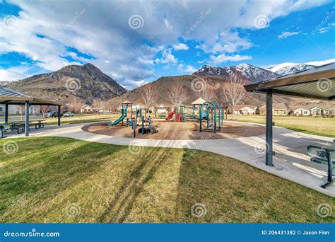 Scenic Public Neighborhood Park With Playgrounds And Pavilions Against