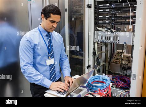 Technician working on laptop Stock Photo - Alamy