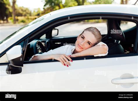 Beautiful Blonde Woman Driving A White Car Stock Photo Alamy