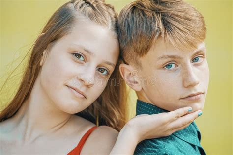 Young Beautiful Couple On A Yellow Background Close Up Portraits Stock