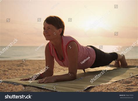 Mature Woman Doing Gymnastic Exersices Sea Stock Photo 706617073 Shutterstock