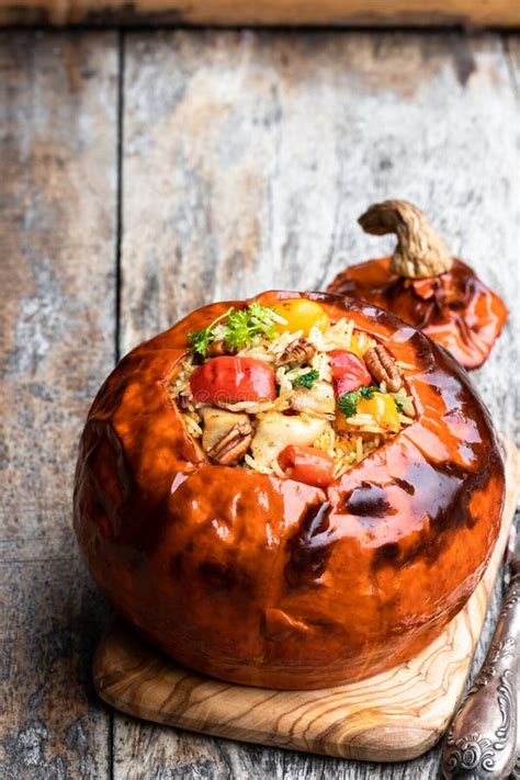 Baked Pumpkin Stuffed With Rice And Chicken On Wooden Table Stock Image