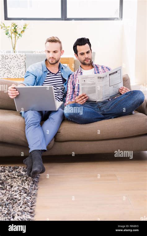 Gay Couple Relaxing On The Couch Stock Photo Alamy
