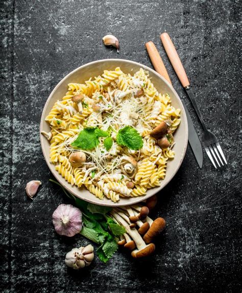 Premium Photo Fusilli Pasta With Mushrooms Garlic And Mint Leaves