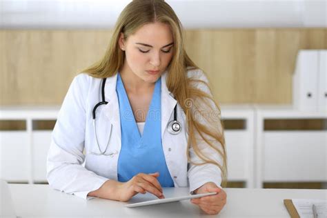 Woman Doctor Using Tablet Pc In Hospital Or Clinic Blonde Therapist