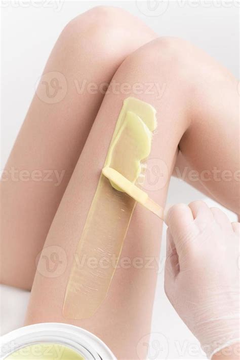 Applying Hot Wax On Slim Woman Leg Using Spatula Professional Depilation Waxing In Beauty