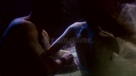 Naked Man And Woman In Gorgeous Dress Are Swimming Inside Water Of Sea Or Ocean Stock Video