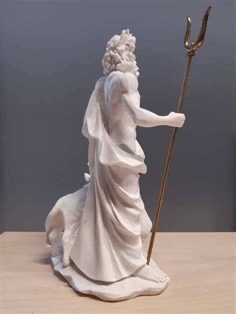 A Statue Of A Woman Holding A Staff