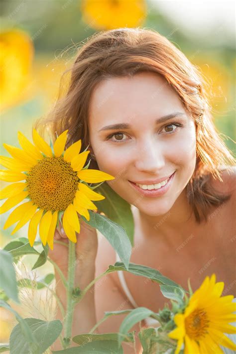 Premium Photo Beautiful Young Woman In The Sunflower Field Portrait