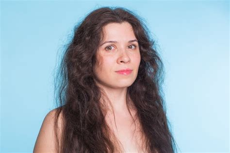 Premium Photo Portrait Of Sensual Nude Woman With Curly Hair On Blue