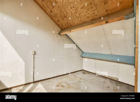 The Inside Of An Unfinished Room With Wood Paneling And White Paint On