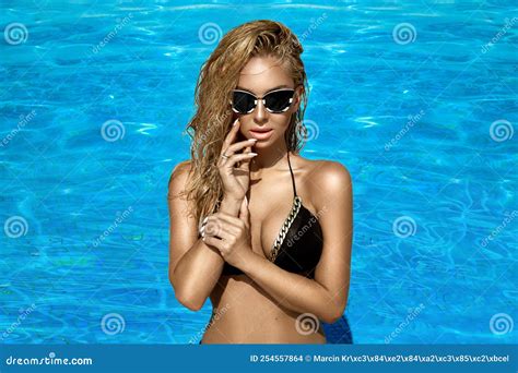 Beautiful Tanned Woman In Elegant Swimsuit In Pool Elegant Glamour Girl In Trendy Bikini Is
