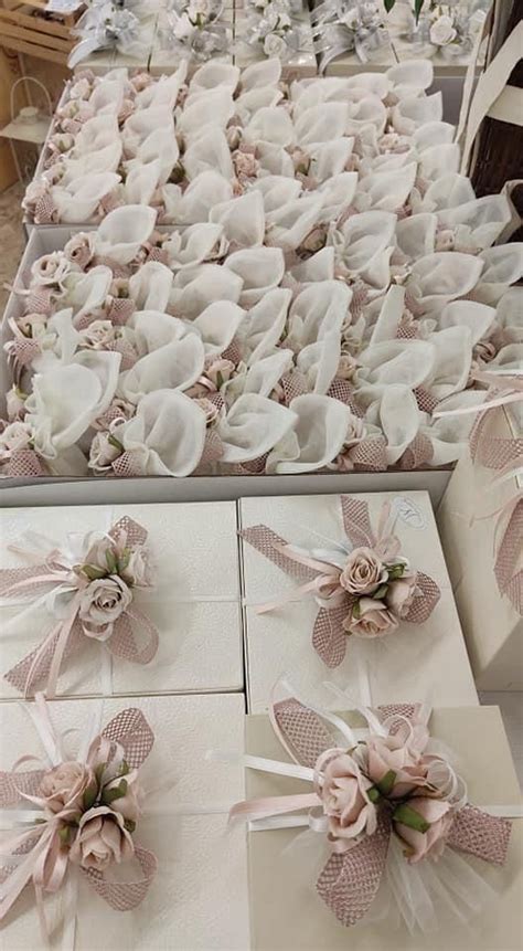 Several White Boxes With Pink Bows And Flowers On Them Are Sitting On A