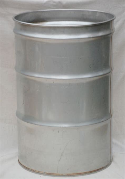 A Metal Barrel Sitting On Top Of A White Sheet