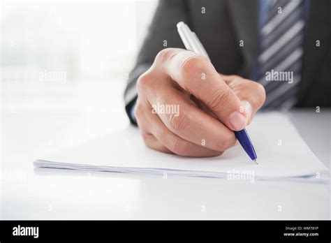 Mature Businessman Writing On Document In His Office Stock Photo Alamy