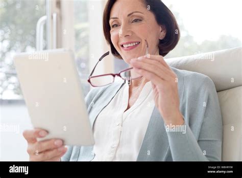 Mature Woman Using Digital Tablet Stock Photo Alamy
