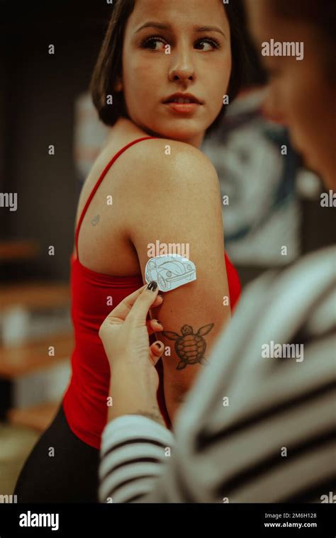 Beautiful Brunette Girl Is Trying Her Tattoo Design On Her Hand Stock Photo Alamy