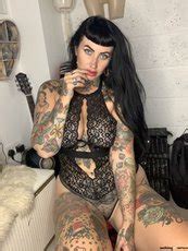 Dark Haired Tattooed Model Cherrie Pie Shows Off Her Big Ass And Tits Photos