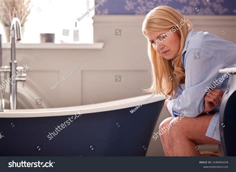 Menopausal Mature Woman Suffering Incontinence Sitting Stock Photo