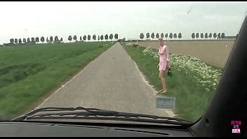 An Unidentified Blonde Woman Wearing A Pink Dress Is Forcefully Confronted By Two Truck Drivers