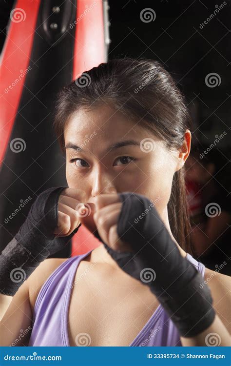 Portrait Of Determined Female Boxer In Fighting Stance Looking At