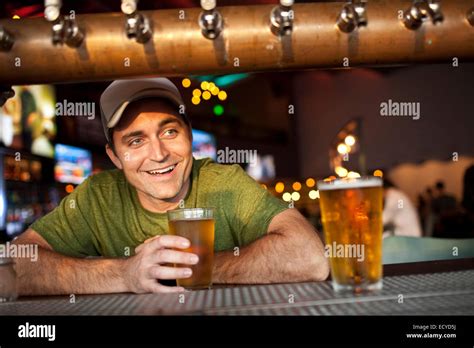 Caucasian Man Drinking Beer In Bar Stock Photo Alamy