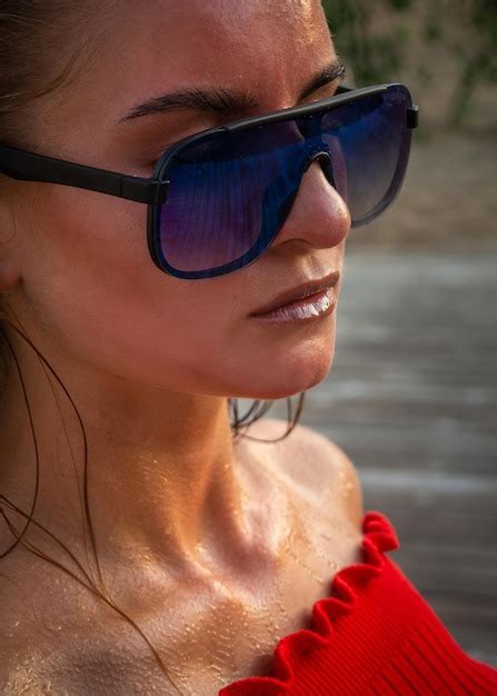 Premium Photo Beautiful Brunette Model In A Red Sweater And Dark Glasses Poses In Front Of The