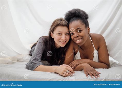 Two Cheerful Lesbian Girls Lying Close To Each Other In Bed Stock Photo Image Of Caucasian