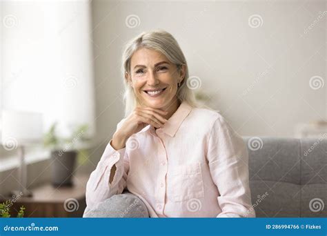 Happy Blonde Mature Woman Posing At Home Looking At Camera Stock Photo Image Of Cheerful